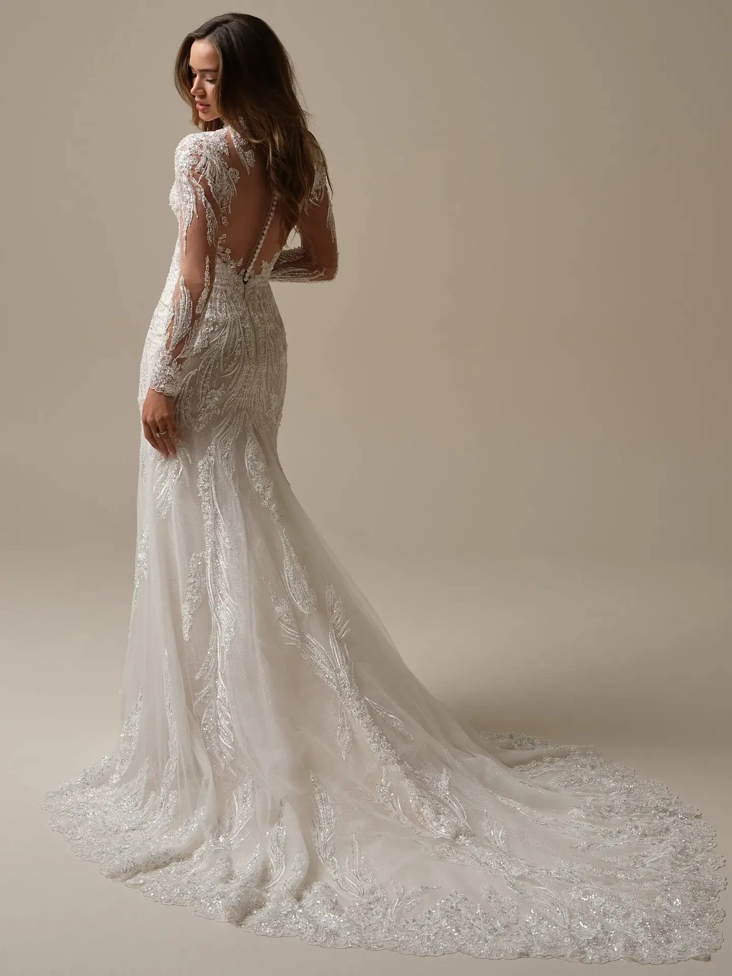 Beaded fit and flare wedding dress by Maggie Sottero, illusion long sleeve bridal gown with overskirt