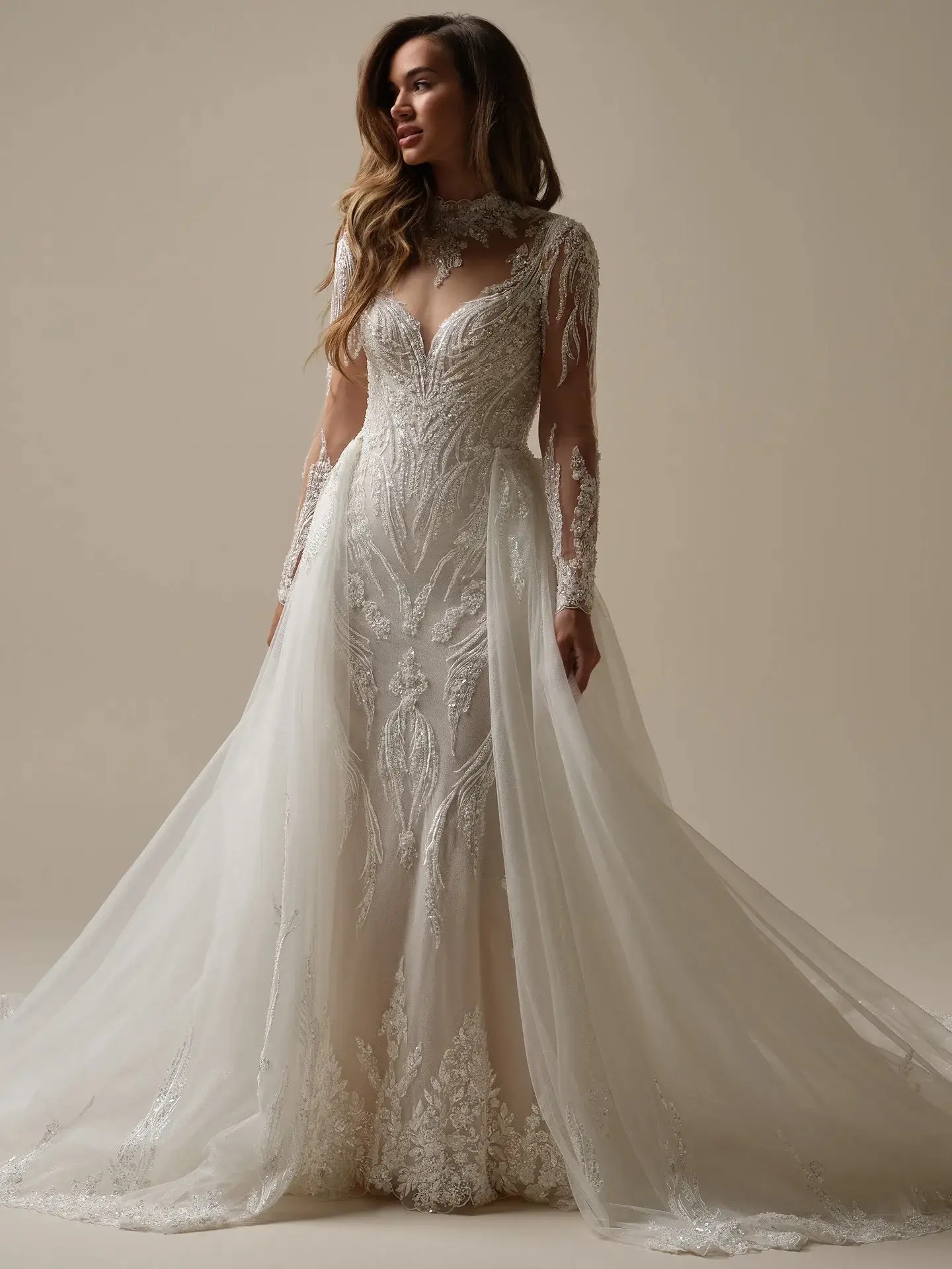 Beaded fit and flare wedding dress by Maggie Sottero, illusion long sleeve bridal gown with overskirt